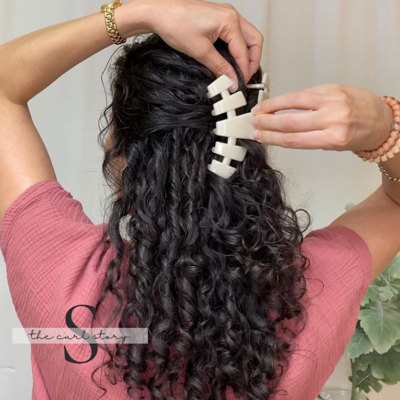 Large almond beige Teleties claw clip in a half up hairstyle on curly hair.